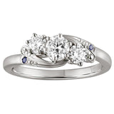 Bespoke trilogy diamond ring in platinum with three round diamonds and blue sapphire shoulder stones in platinum. Made in London