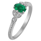 oval emerald with diamond accents and laurel engraved platinum band by a Hatton Garden jeweller in London