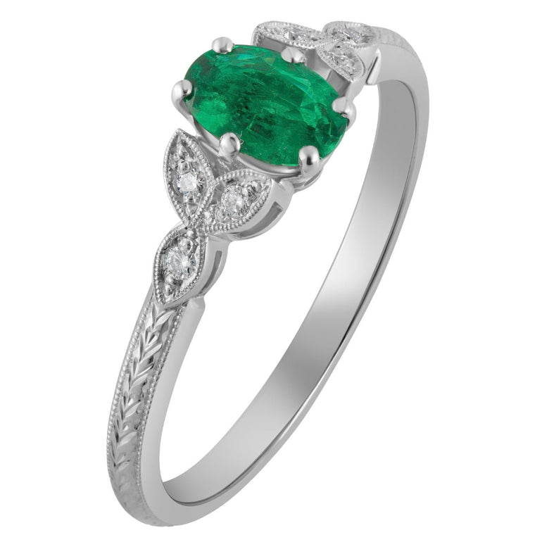 oval emerald with diamond accents and laurel engraved platinum band by a Hatton Garden jeweller in London