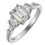 Emerald cut diamond ring with trapezoids in platinum