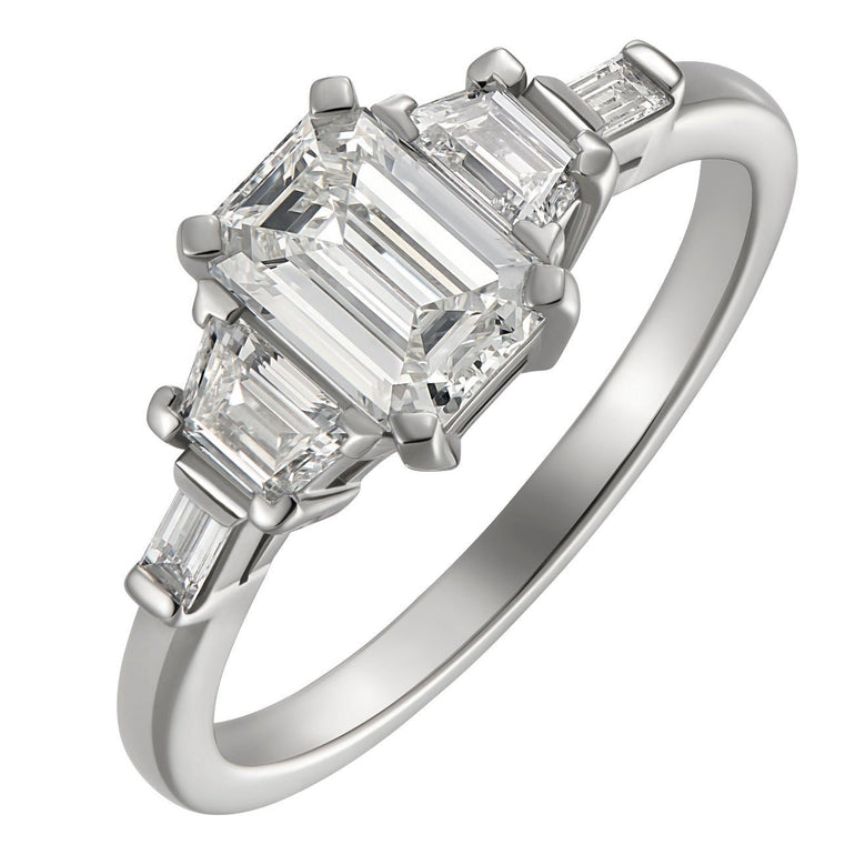 Emerald cut diamond ring with trapezoids in platinum