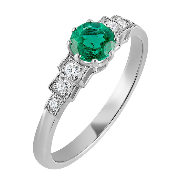 Emerald green engagement ring with diamonds on shoulders in platinum