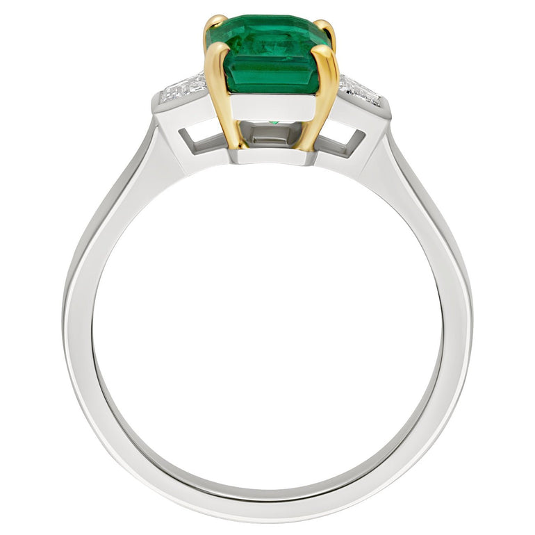 Emerald cut emerald with traps diamonds 18ct yellow claws with platinum band. Made in Hatton Garden