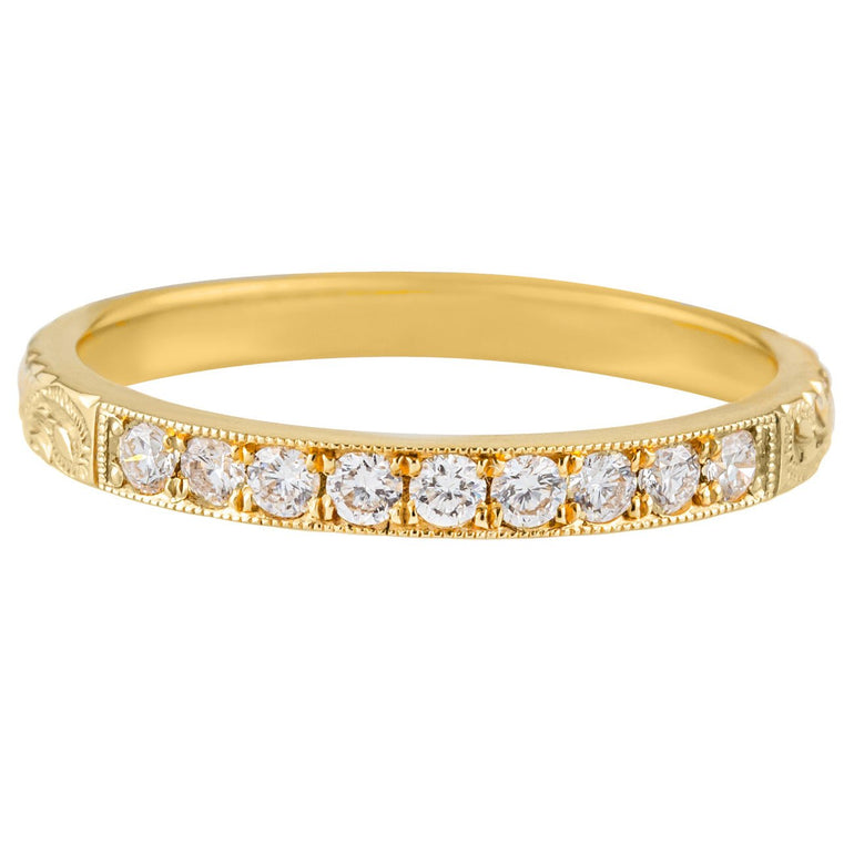 Engraved yellow gold wedding band with diamonds