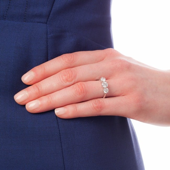 Platinum diamond trilogy ring on hand