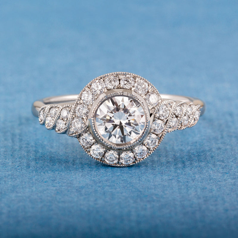 Round diamond cluster ring with spiral diamond shoulders