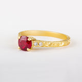 Ruby engagement ring in yellow gold with four claws and patterned band UK