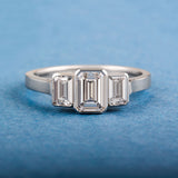 Three stone emerald cut diamond ring