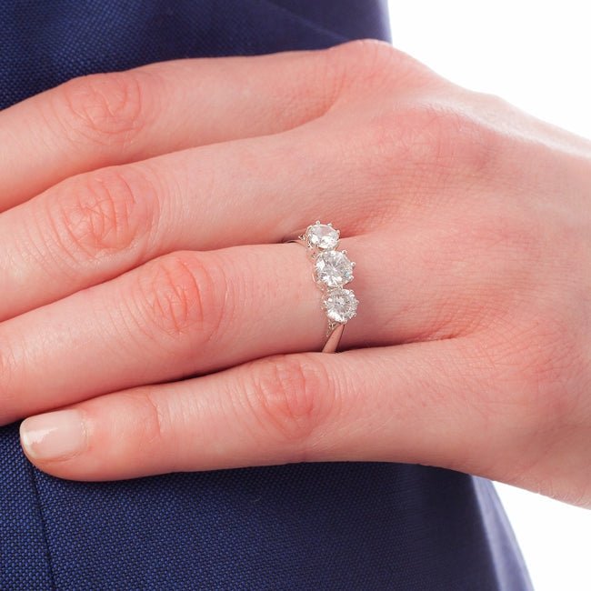 Trilogy engagement ring on hand