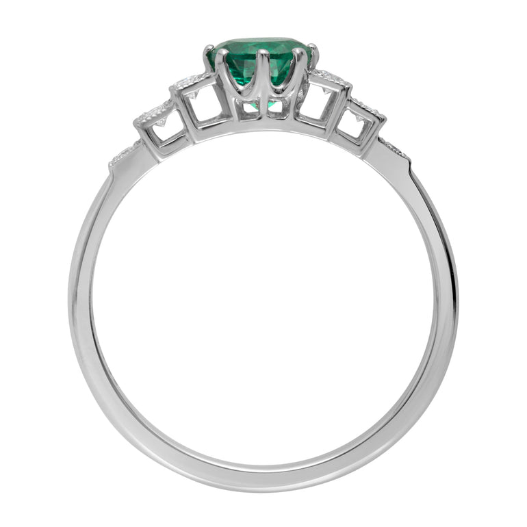 Vintage emerald engagement ring with diamond set shoulders in platinum
