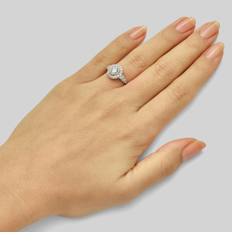 Edwardian style round halo diamond engagement ring