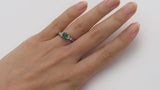 Emerald engagement ring with diamond accents in platinum