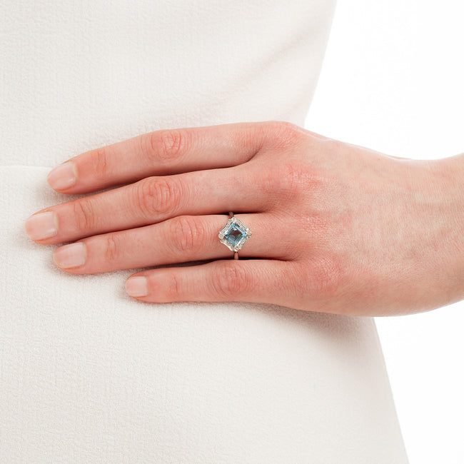 Aquamarine engagement ring with diamonds on hand