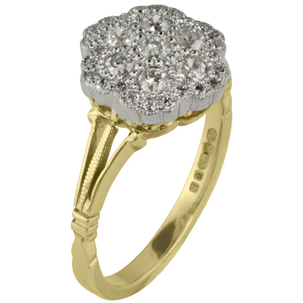 Diamond cluster ring with split shoulders in vintage style.