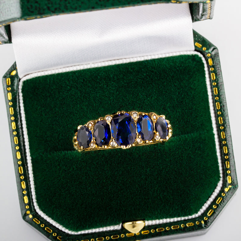Five stone blue sapphire half hoop ring in box