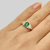 Emerald and diamond three stone ring in yellow gold