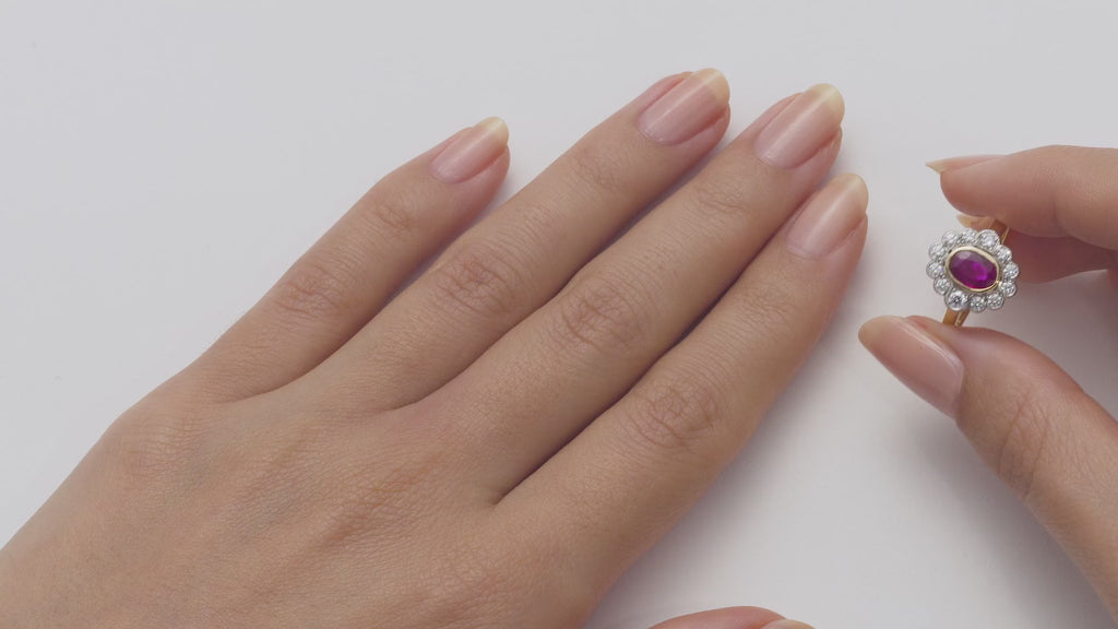 Oval ruby and diamond cluster ring in platinum and yellow gold