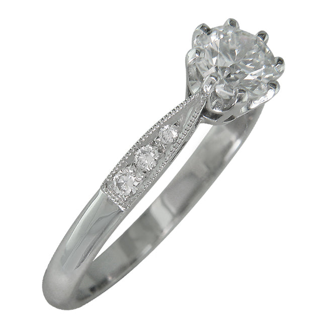 Diamond platinum ring with diamond accent shoulders in 1930s style.