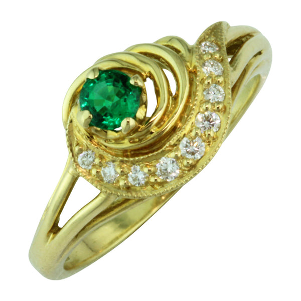 Comet ring with central emerald and diamond tail.
