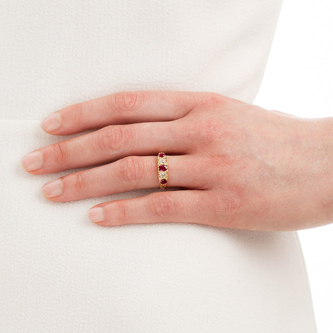 five stone ruby and diamond ring on hand