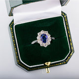 Oval blue sapphire cluster ring
