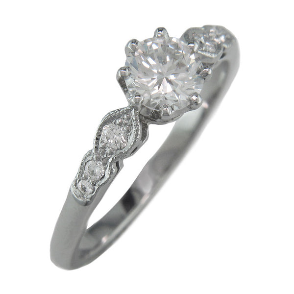 Antique ring design with diamond accents on band.