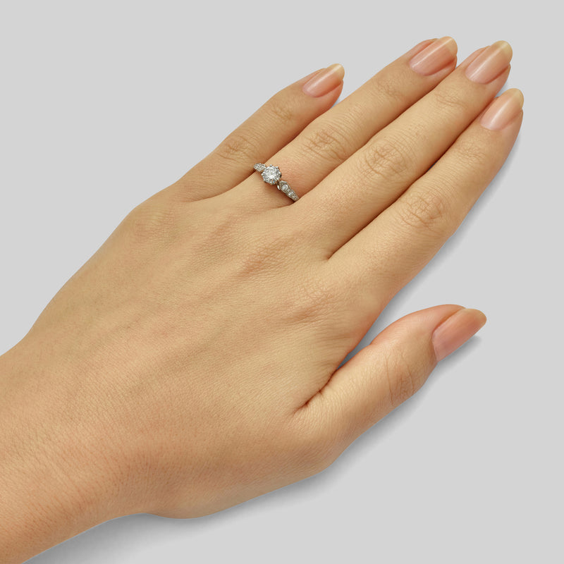 Edwardian style round diamond ring with side stones