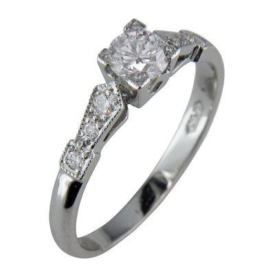Decorative Art Deco style engagement ring with square central design.