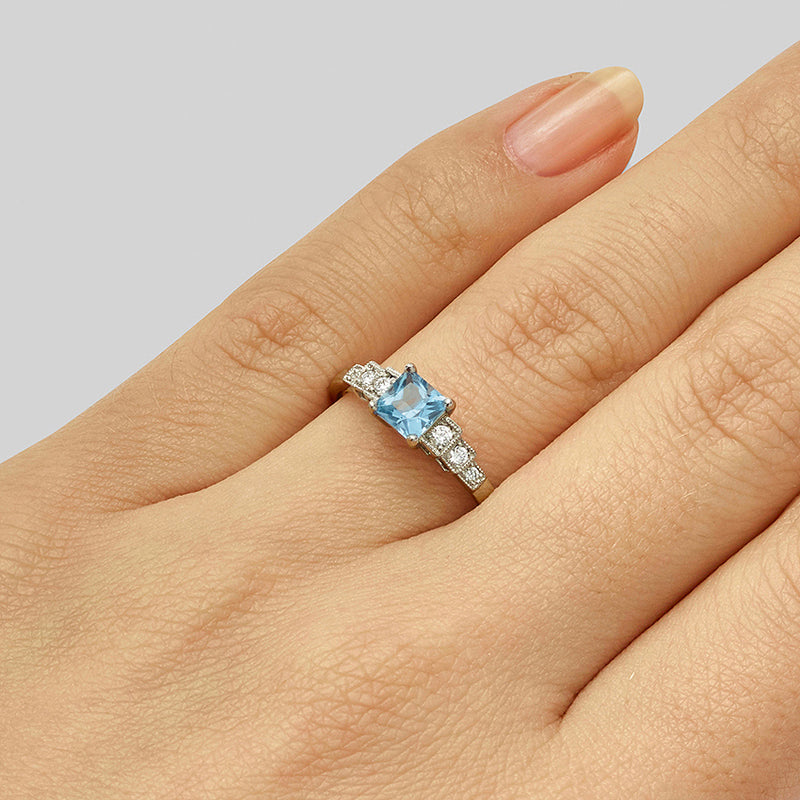 Art Deco style aquamarine ring with diamond stepped shoulders in platinum