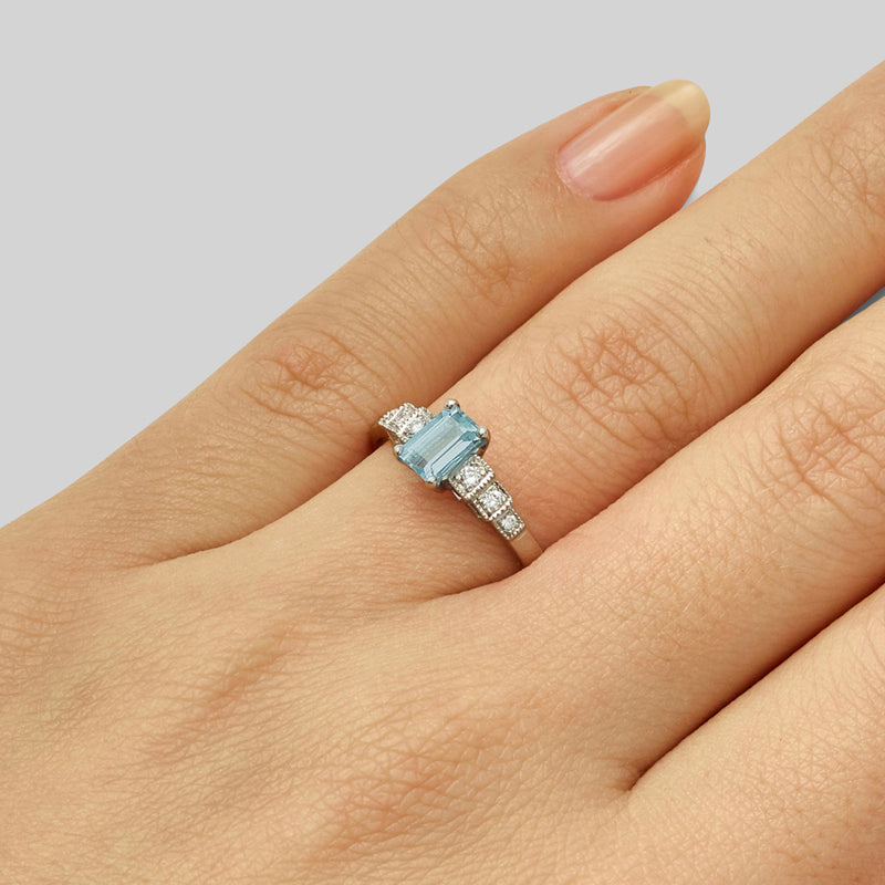Emerald cut aquamarine ring with diamond side stones