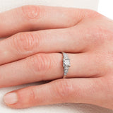 Princess cut engagement ring with diamond band on hand
