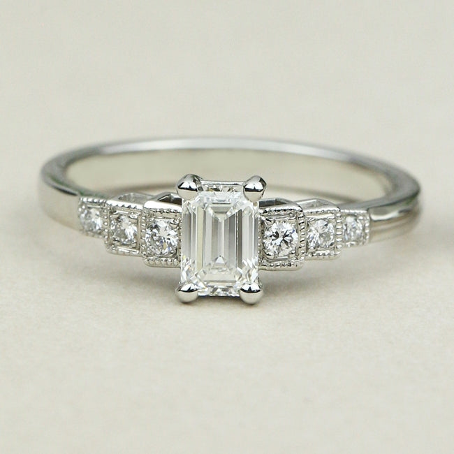 Art Deco emerald cut diamond engagement ring with diamond band 