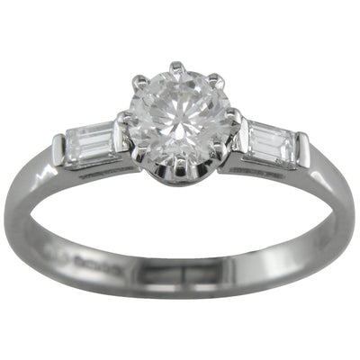 Vintage round diamond engagement ring with baguette diamond side stones