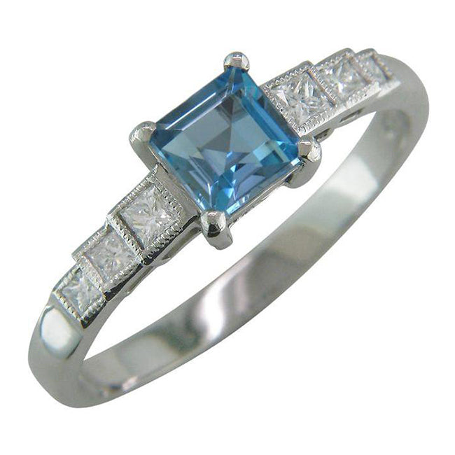 Aquamarine engagement ring with princess cut diamond shoulder side stones.