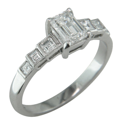 Vintage Art Deco style diamond ring with an emerald cut diamond.