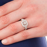 Asscher cut engagement ring on hand.
