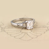 Emerald cut diamond ring with baguettes on paper