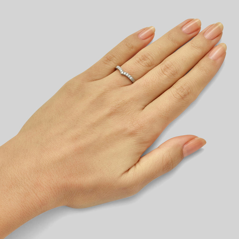 Patterned wishbone diamond wedding ring on hand