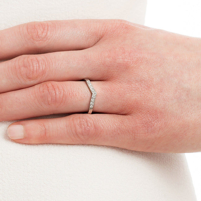 V-shape diamond wedding ring in platinum on hand
