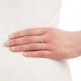 shaped wedding ring with pave set diamonds on model