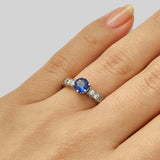 Brilliant cut sapphire engagement ring on hand