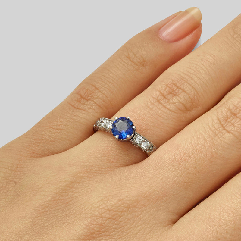 Brilliant cut sapphire engagement ring on hand