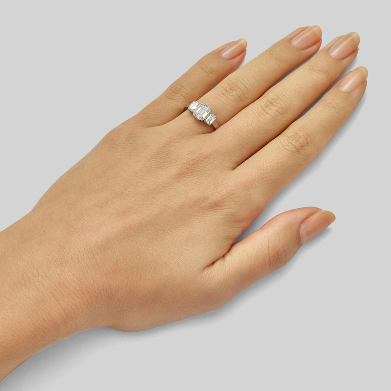 Three stone rubover diamond ring with emerald-cut diamonds