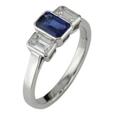 Sapphire engagement ring in Art Deco style with emerald cut diamonds.