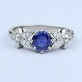 Floral ring with blue sapphire and diamond leaves