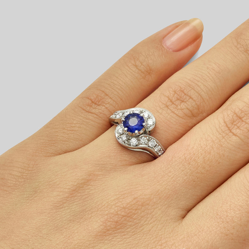 Unusual sapphire ring with a diamond swirl in platinum