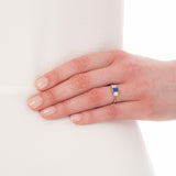 Emerald cut sapphire engagement ring on model