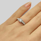 Platinum diamond engagement ring with stepped diamond shoulders