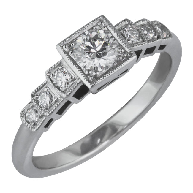 Art Deco engagement ring with square setting for a round diamond.