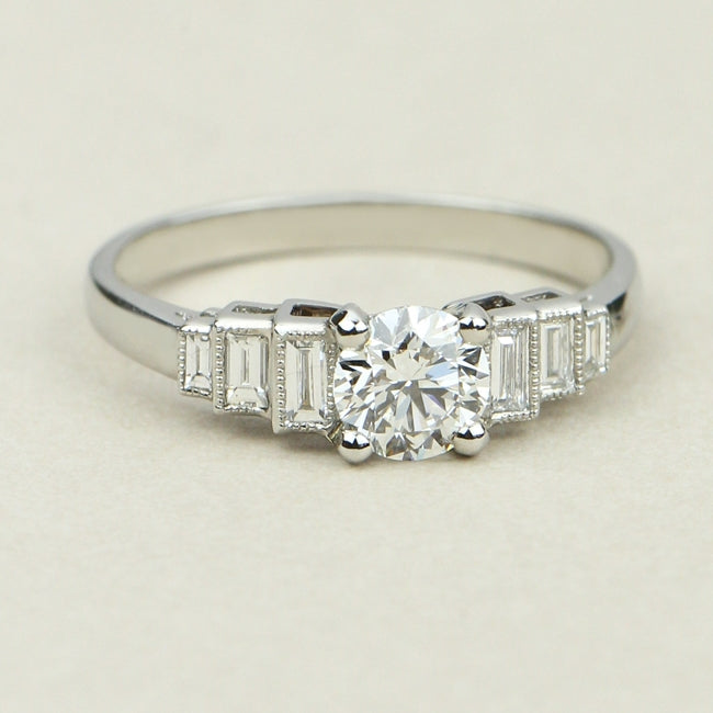Round diamond ring with baguettes in platinum